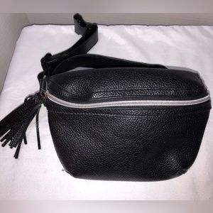 Fringed, leather, zipper, heavy duty buckle hip sack.